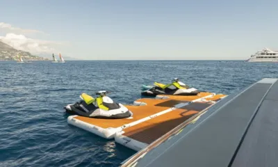 Seawolf X: Two personal watercraft on a floating dock beside the yacht at sea