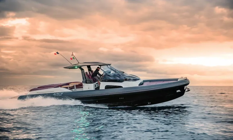 Seawolf X: Dark inflatable tender speeding across the sea under an orange sunset sky