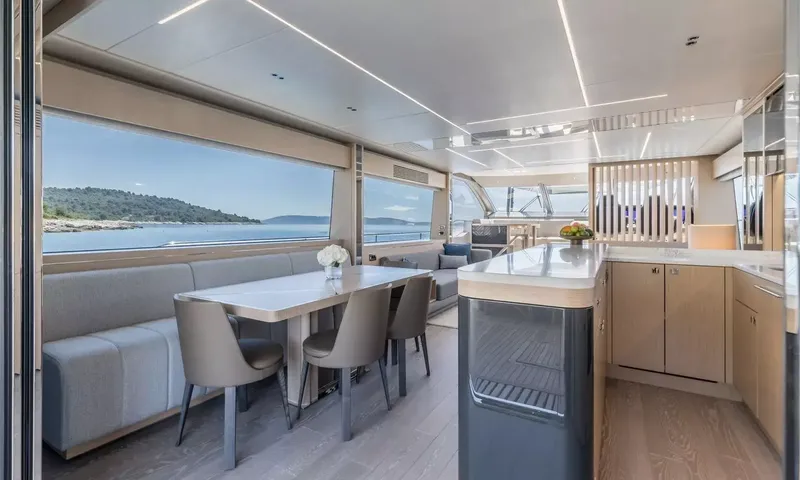 Ascend: Indoor dining table with chairs and bench seating beside the galley counter