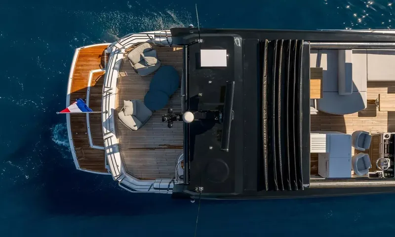 Ascend: Overhead view of the stern showing teak aft deck with lounge chairs and flybridge seating