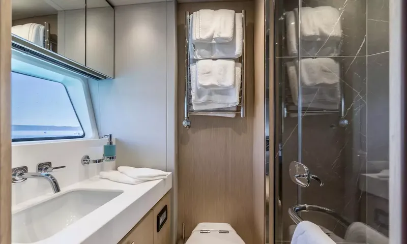 Ascend: Compact bathroom with basin, towel rail, toilet and marble shower