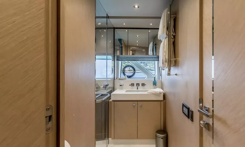 Ascend: Doorway view into an ensuite with vanity basin, mirrors and towel rail