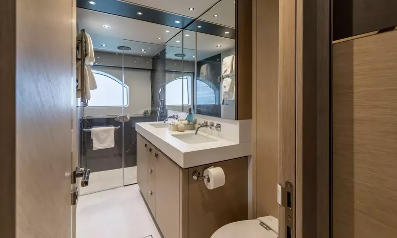Ascend: Ensuite bathroom with walk in glass shower, white vanity sink, mirrors and toilet