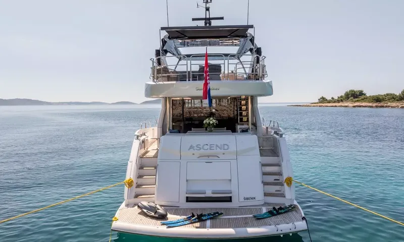 Ascend: Stern view of the yacht at anchor with water skis and underwater scooter on the swim platform
