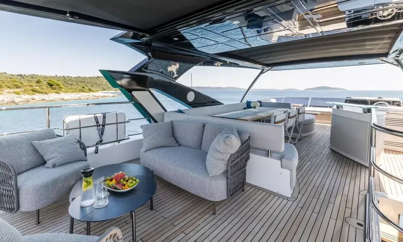 Ascend: Spacious upper deck with lounge sofas, coffee table, dining area and teak flooring