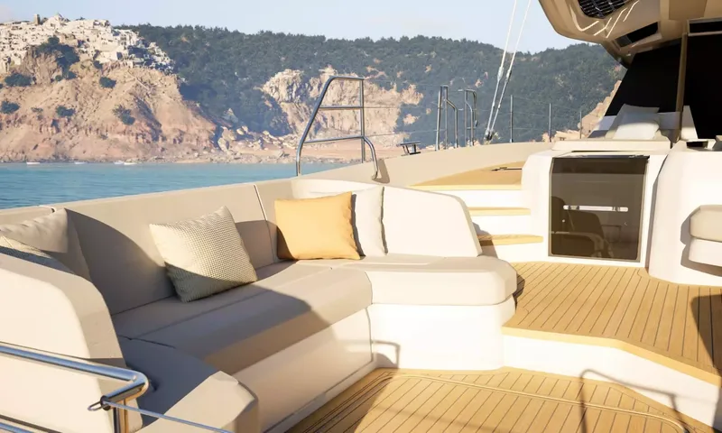 Elly II: Cushioned sofa on the aft deck with hillside coastline behind
