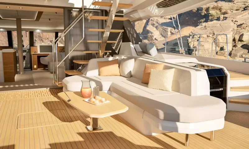 Elly II: Aft deck lounge sofa with table, carafe and stairs leading up
