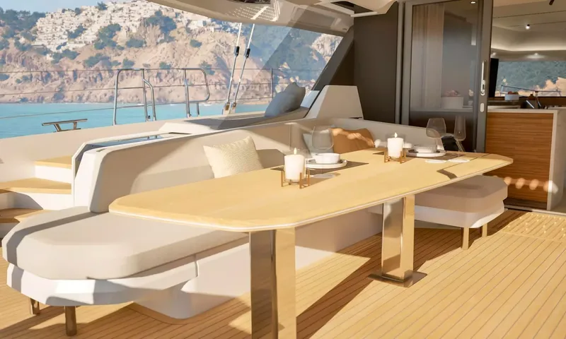 Elly II: Outdoor dining table set with candles and glasses on the aft deck