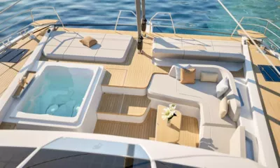Elly II: Foredeck with built in jacuzzi, sunpads and a curved sofa around a small table