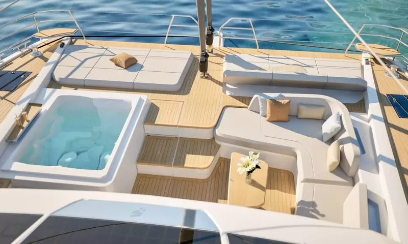 Elly II: Foredeck with built in jacuzzi, sunpads and a curved sofa around a small table
