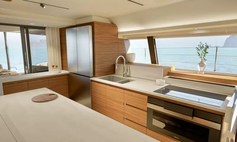 Elly II: Galley with fridge, sink, cooktop and oven under a wide sea view window