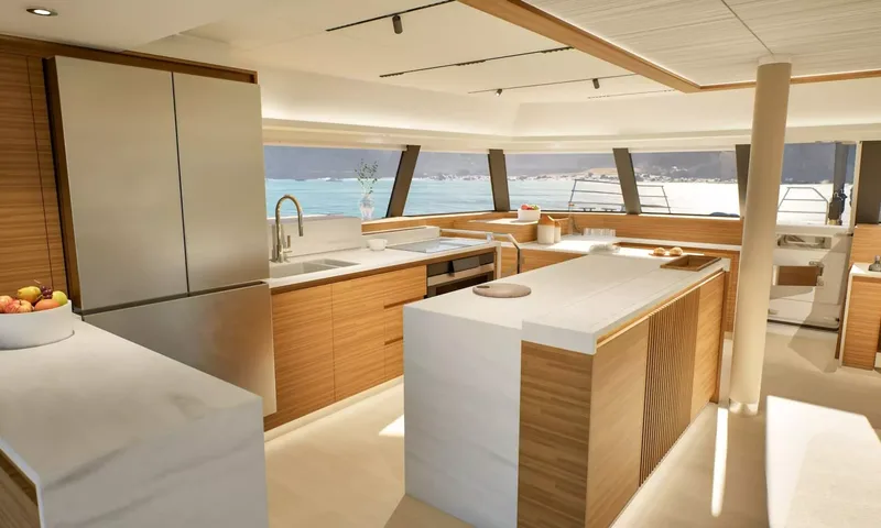 Elly II: Galley island and wood cabinetry with panoramic windows onto the sea