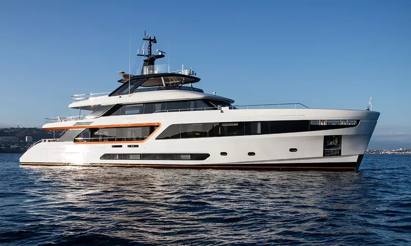 Angel: Side profile of a white motor yacht at anchor under a clear sky
