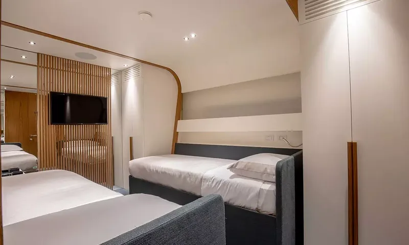 Angel: Twin cabin with two single beds, wall television and fitted wardrobes