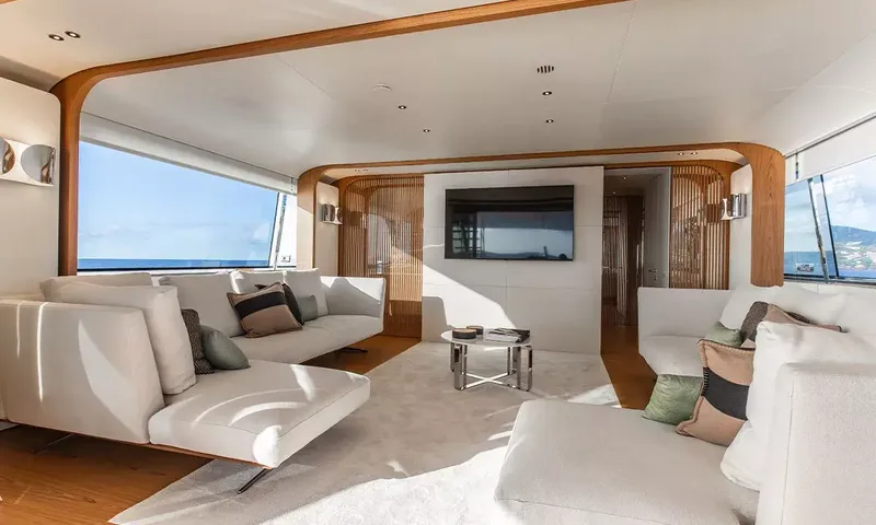 Angel: Lounge with white sofas, cushions, coffee table and wall television