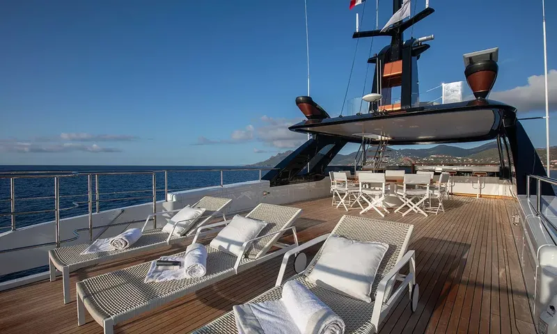 Angel: Top deck with wicker sun loungers, towels and a shaded dining area under the mast