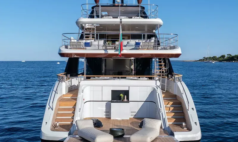 Angel: Stern view showing teak stairs, swim platform with loungers and decks above