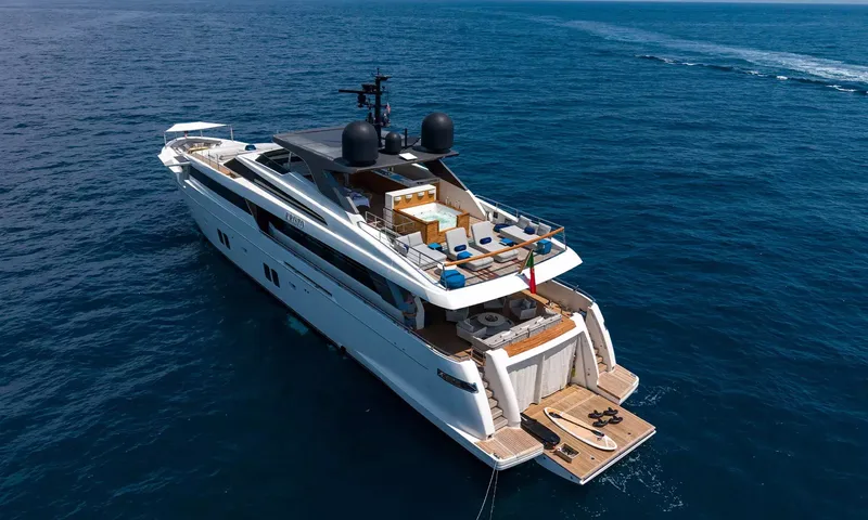 Kristo: Overhead view of the yacht at sea showing upper deck jacuzzi, aft lounge and swim platform with paddleboard