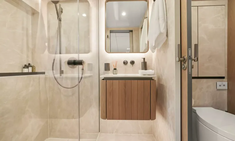 Amitatu: Ensuite with glass shower, wooden vanity, backlit mirror and toilet
