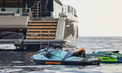 Amitatu: Jet ski floating beside the yacht's stern steps with a towable alongside