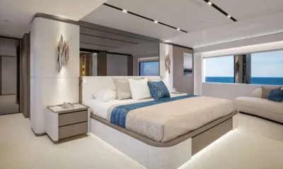 Yoto: Spacious cabin with double bed, blue runner, sofa and wide sea view window