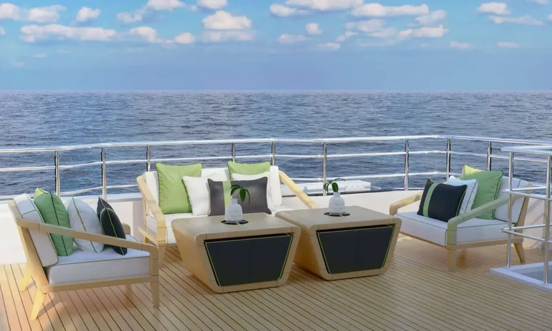 Yoto: Open deck lounge with armchairs, green cushions and low tables facing the sea