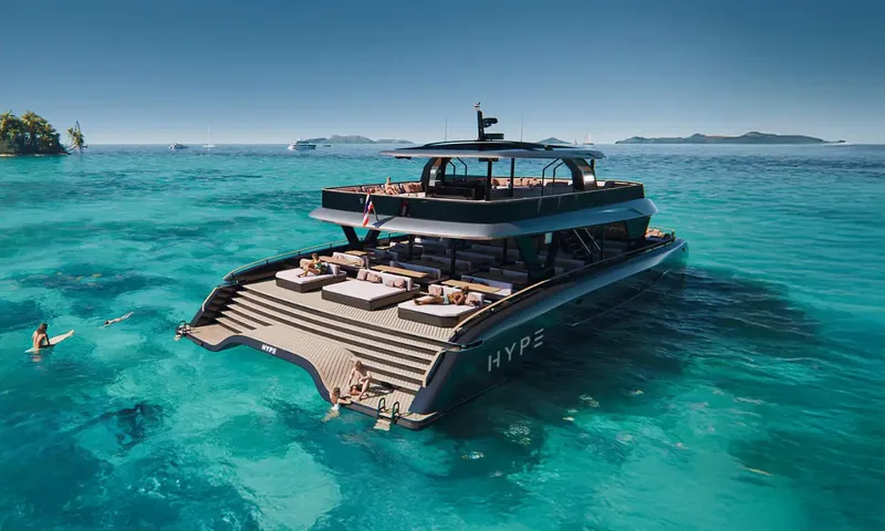 HYP3: Stern view of catamaran with wide stepped swim platform, sunbeds and guests swimming in clear water