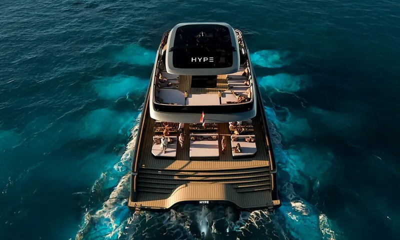 HYP3: Aerial stern view of catamaran under way at golden hour with guests on sunbeds