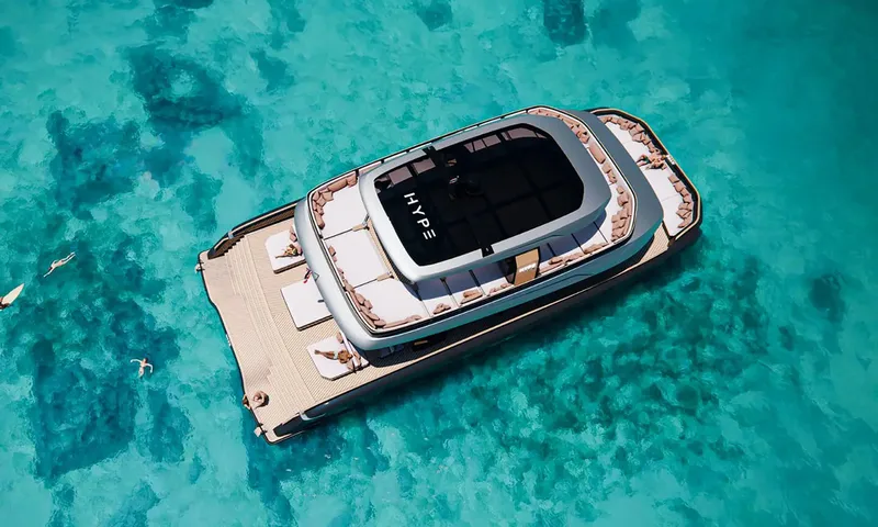 HYP3: Aerial view of catamaran anchored over clear turquoise water with swimmers nearby