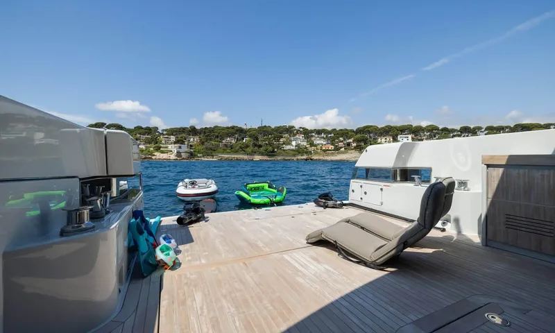 Jamon: Teak aft deck with lounger, snorkel gear and water toys floating beyond