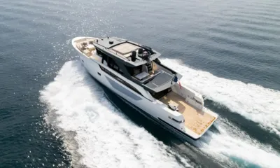 CC: Yacht under way seen from above, white wake trailing behind its teak aft deck