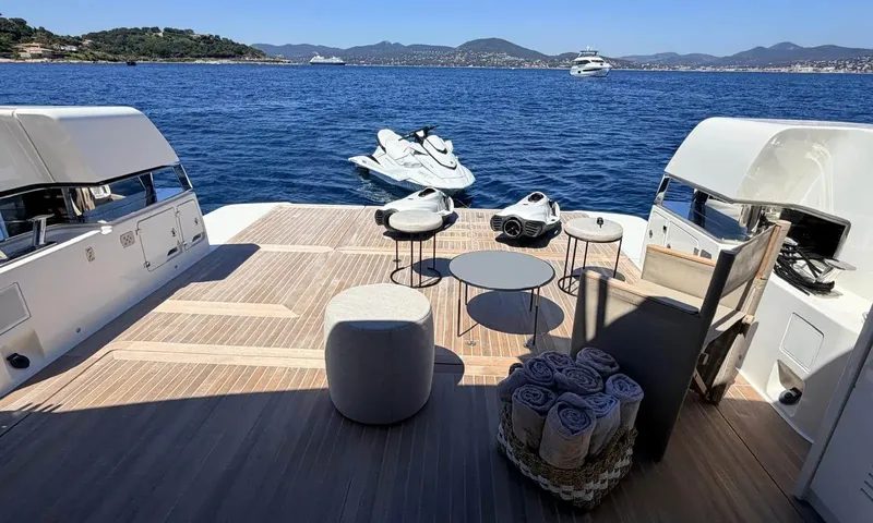 CC: Teak aft deck with stools, towels basket, two underwater scooters and a jet ski behind