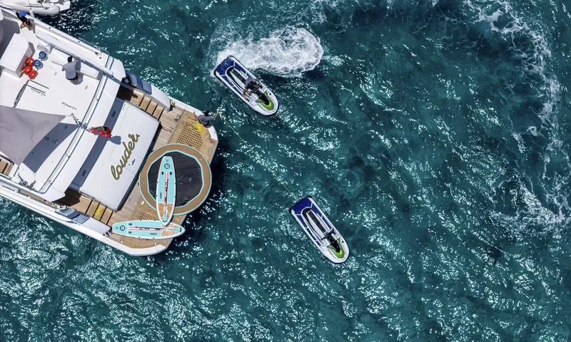 Louder: Overhead view of the yacht stern with paddleboards, a floating platform and two jet skis