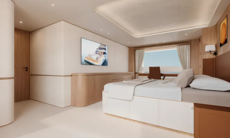 Aitana: Cabin with double bed, wall mounted screen, low cabinet and desk at a large window