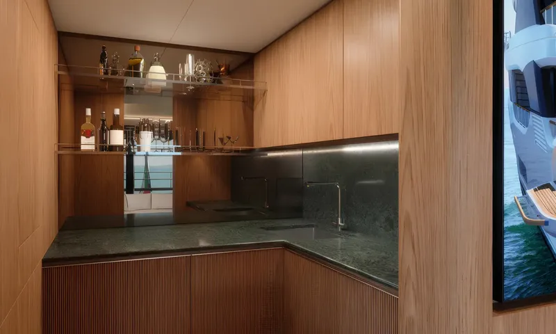 Aitana: Compact pantry bar with green stone counter, sink and glass shelves of bottles