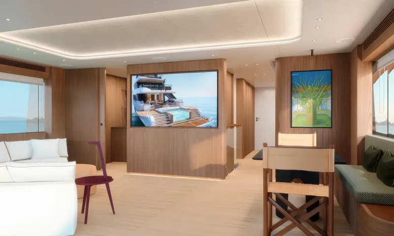 Aitana: Wood panelled lounge with white sofa, screen on a partition and folding chairs at a table