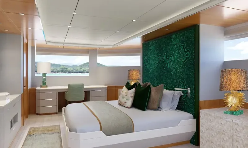Lumière: Cabin with double bed against a green headboard, desk and windows looking out to hills