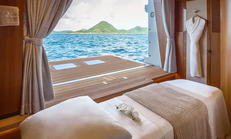 Amor à Vida: Massage table with folded towel and orchid facing an open fold down terrace over the sea