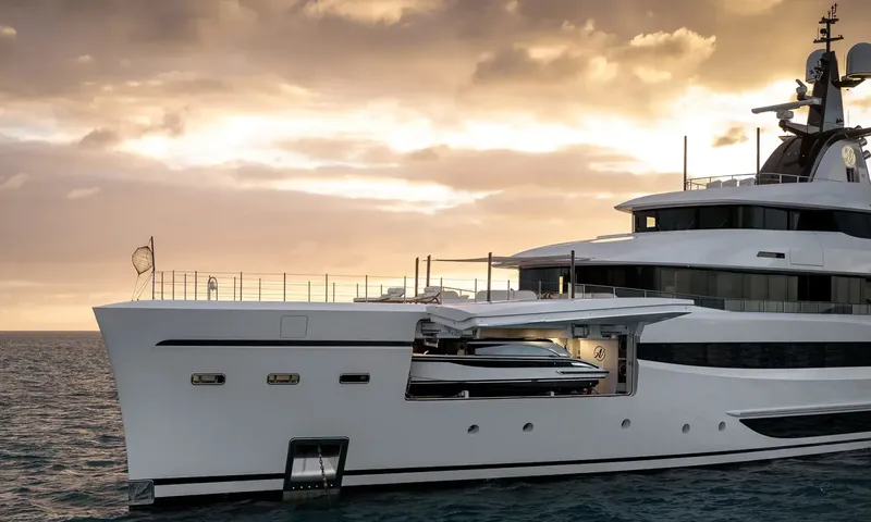 Amor à Vida: Bow of the yacht at sunset with a side garage open showing a stored tender