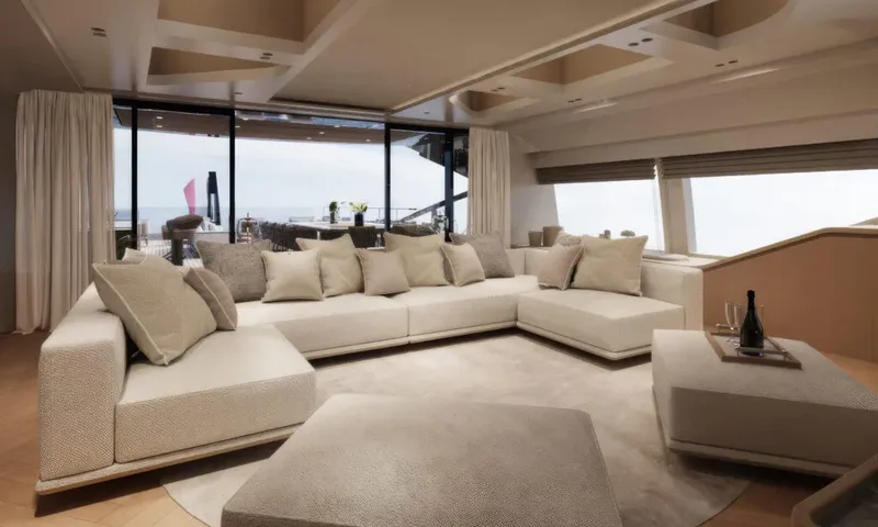 Betsy: Cream sectional sofa facing glass doors that open onto an outdoor deck
