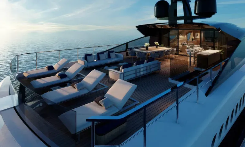 Betsy: Top deck with sun loungers, sofas and dining table overlooking the sea at sunset