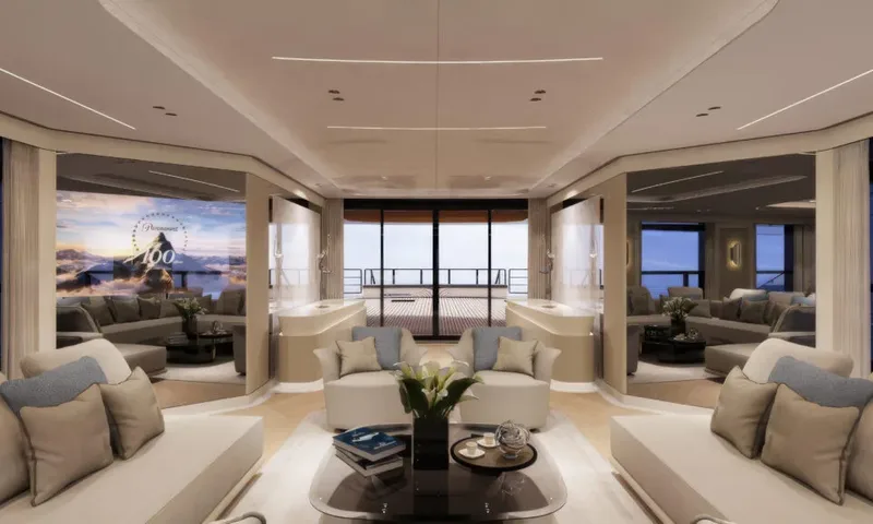 Betsy: Main saloon with armchairs and sofas, a screen on the left and doors to the aft deck