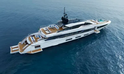 Betsy: Overhead view of white yacht at sea showing open stern decks, loungers and a bow pool