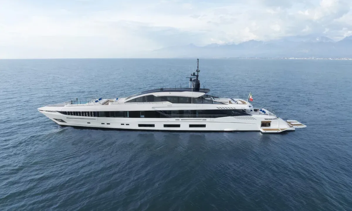 Betsy: White yacht at sea in side profile with mountains on the horizon