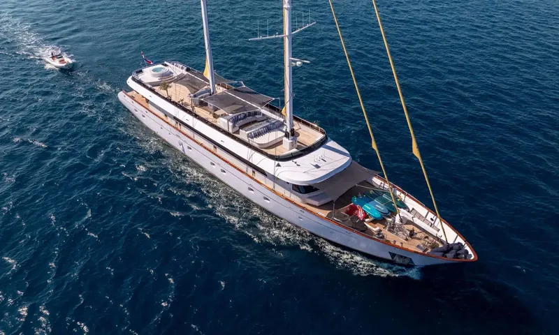 Anima Maris: Aerial view of a two masted yacht under way with a tender following and paddleboards on the foredeck