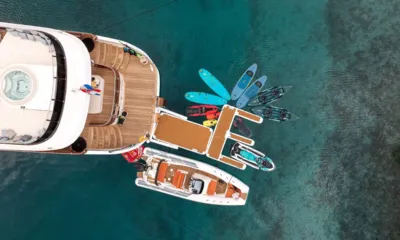 Anima Maris: Overhead view of the stern with paddleboards, kayaks, a jet ski and tender beside a floating platform