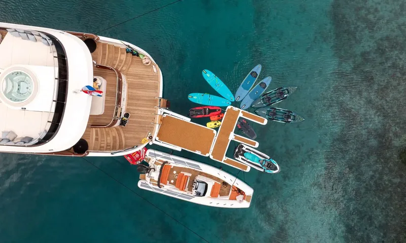 Anima Maris: Overhead view of the stern with paddleboards, kayaks, a jet ski and tender beside a floating platform