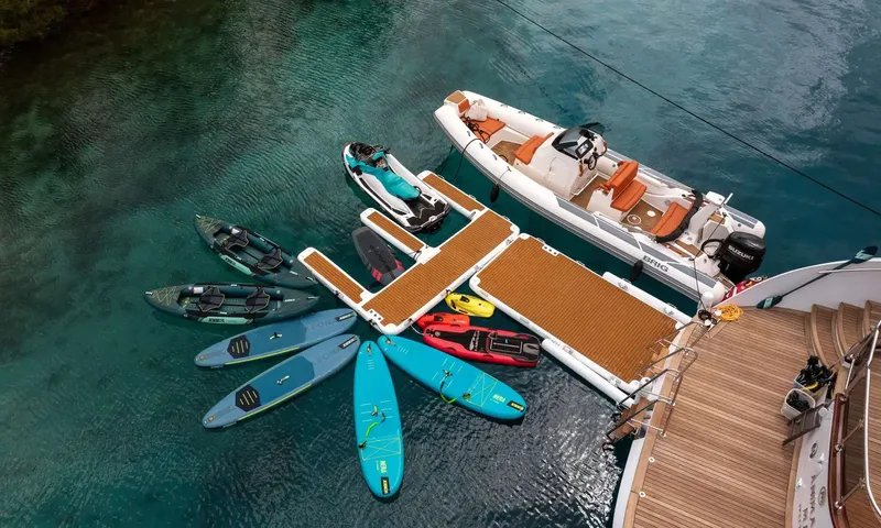 Anima Maris: Water toys around a floating platform beside the stern: tender, jet ski, kayaks, paddleboards, scooters