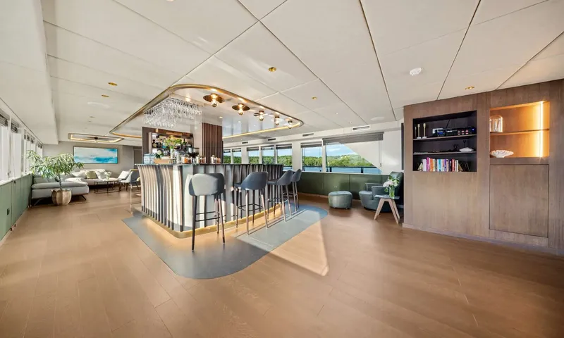 Anima Maris: Spacious saloon with a lit bar, high stools, bookshelves and lounge seating