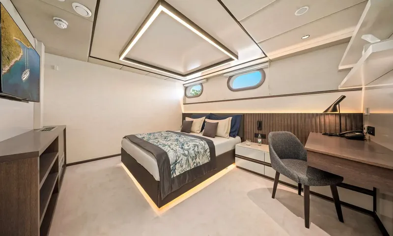 Anima Maris: Double cabin with underlit bed, desk and chair, wall screen and two portholes